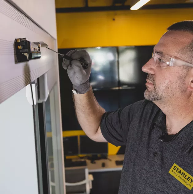 A person installing a set of doors.